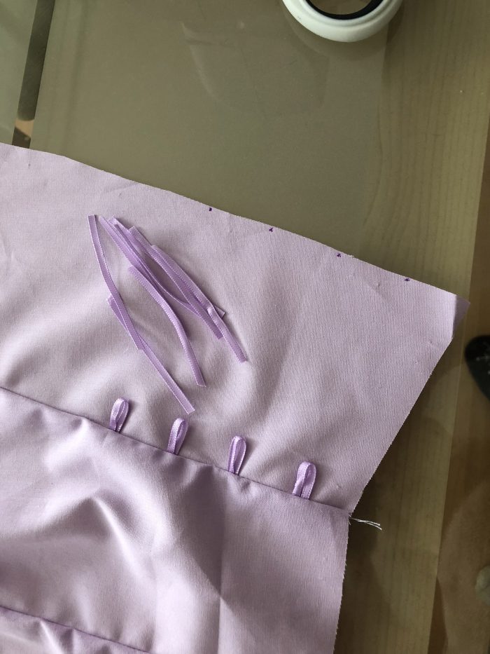 adding the ribbon to create a lace up detail at the sides
