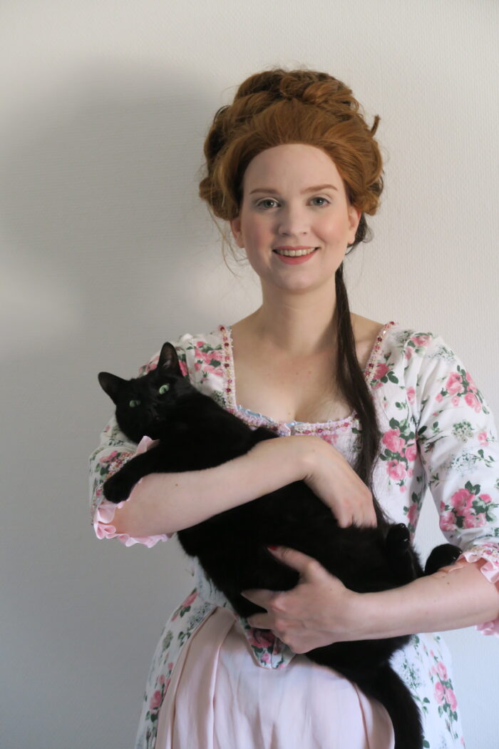 Holding my cat in my 18th century dress